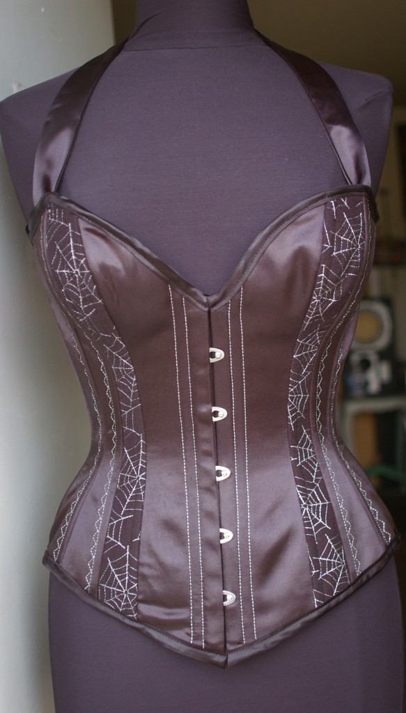 Our deep-cleavage overbust corset with silver metallic spiderwebs & halter straps