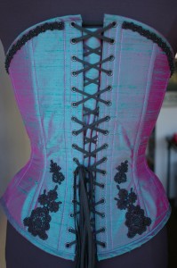 Back view of custom corset by Exquisite Restraint Lace applique on the back of Margo's custom beaded overbust